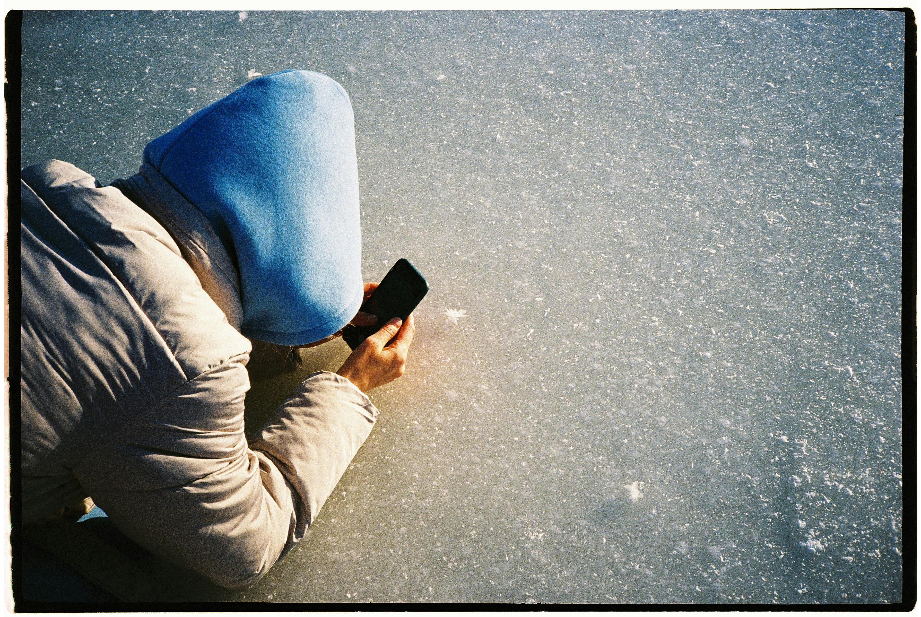 person taking photo of icy patch - frozen walkway slip claim