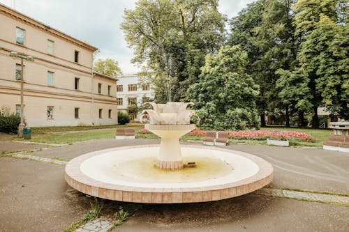 White Concrete Fountain in the Middle of Park