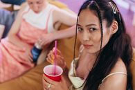 Woman in White Tank Top Holding Red Cup