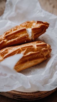 Delectable eclairs presented on rustic parchment, showcasing rich textures.