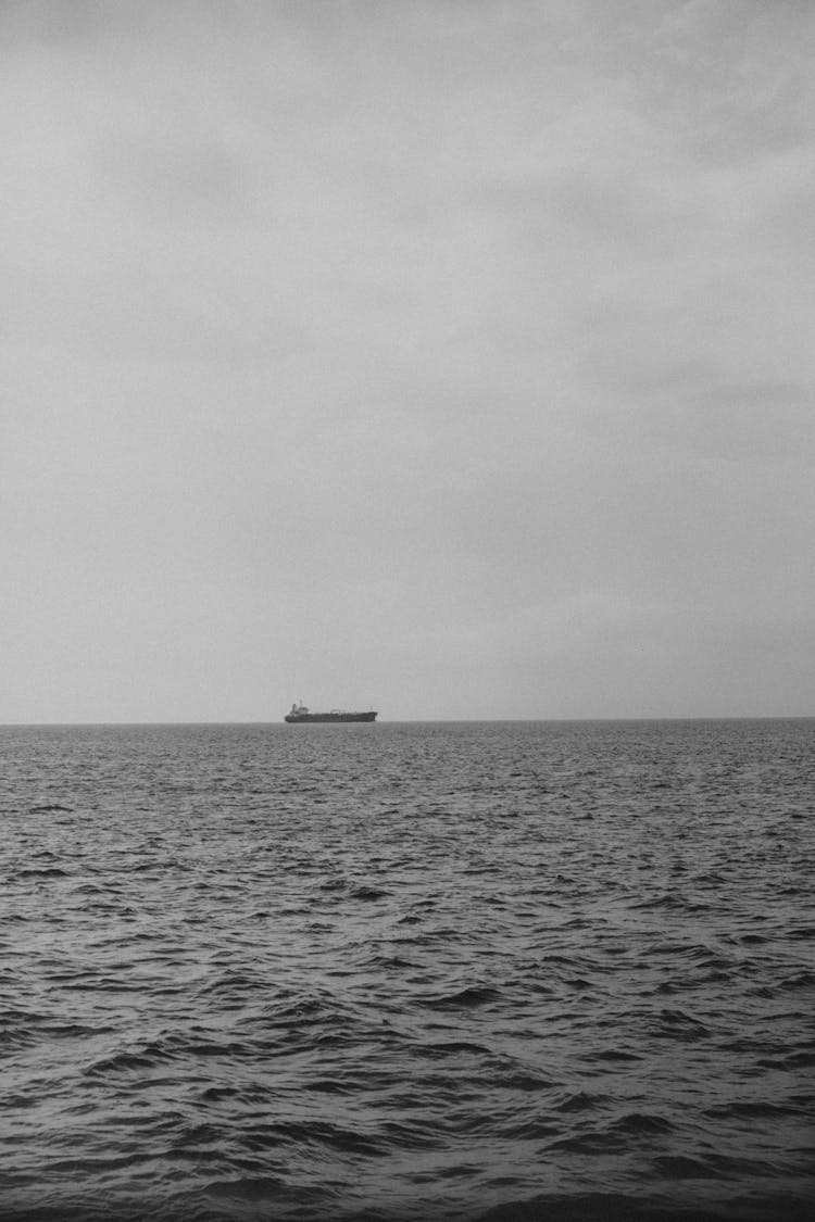 Ship Sailing In Distance On The Sea 