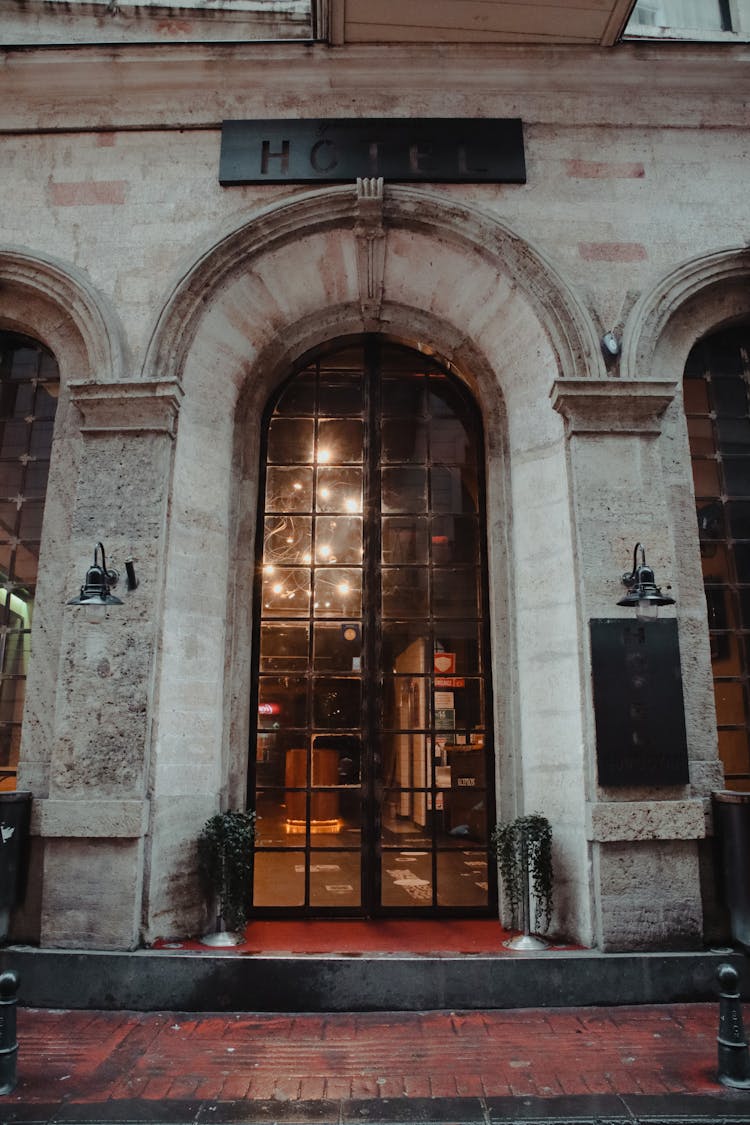 A Hotel Signage Above The Glass Door