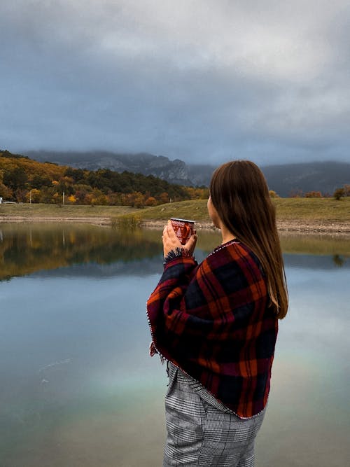 Free Woman in Red and Black Plaid Scarf Standing Near Lake Stock Photo