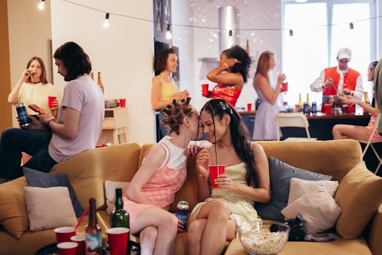 Women Sitting On Brown Sofa