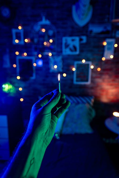 Person Holding Lighted Matchstick 