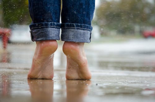 Free Person in Blue Denim Jeans Standing Outside the Rain Stock Photo