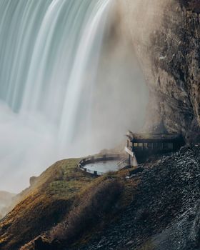 Captivating view of Niagara Falls cascading with mist on a rocky cliff.