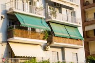 Green Tarpaulin on the Balcony of an Apartment Building
