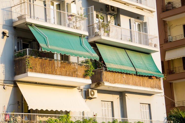 Green Tarpaulin On The Balcony Of An Apartment Building