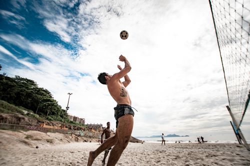 Free A dynamic volleyball game on a sandy beach, capturing the spirit of active leisure. Stock Photo