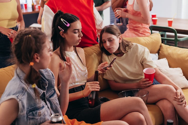 Young Women Looking At A Mobile Phone