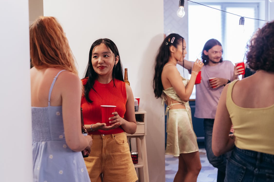 Free People Drinking from Red Plastic Cups in a House Party Stock Photo