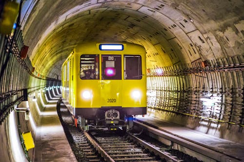 Yellow and Black Train Under Tunnel