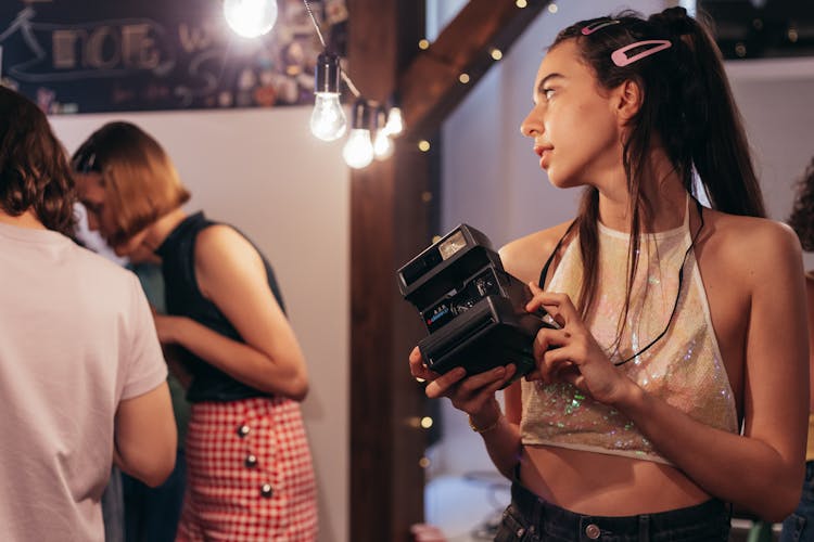 Woman Holding A Polaroid Camera