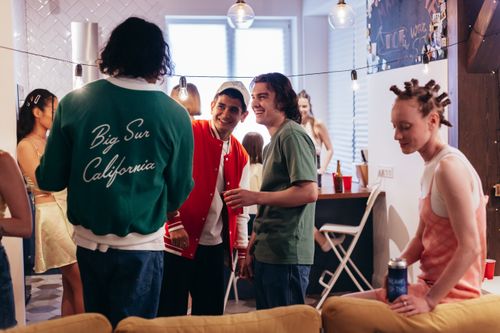 Free A vibrant indoor party scene with friends enjoying drinks and conversation. Stock Photo