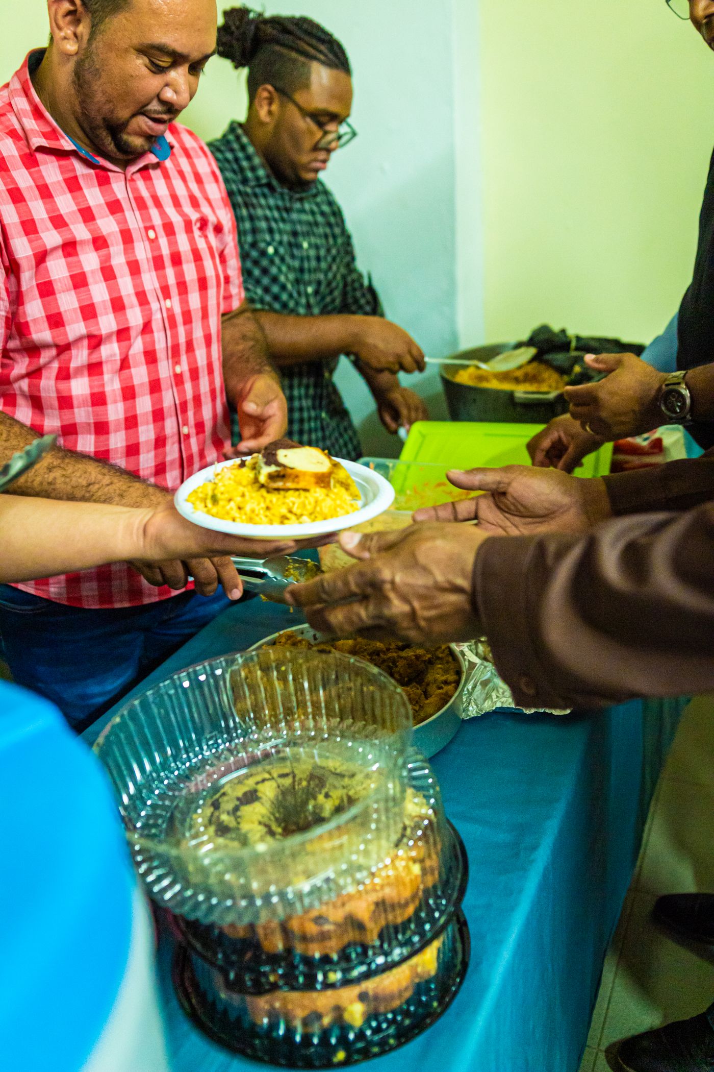 Volunteers serving prepared meals at a community gathering