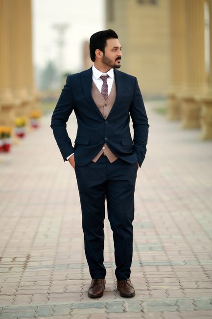 Stylish man in a navy suit stands confidently outdoors in Multan, Pakistan. - Choosing the Right Fabric for the Occasion