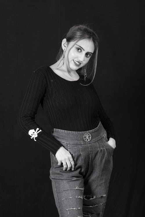 A Woman in Black Long Sleeve Shirt and Blue Denim Jeans