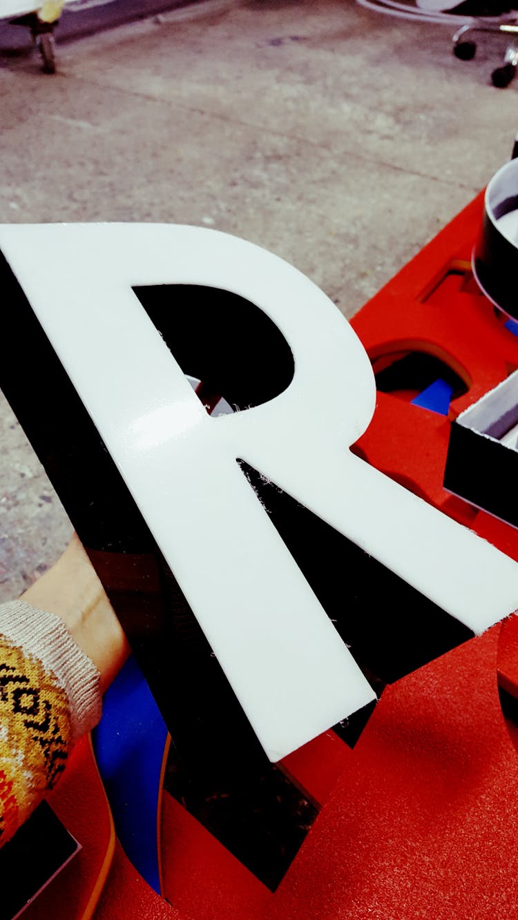 Person Holding White R Marquee