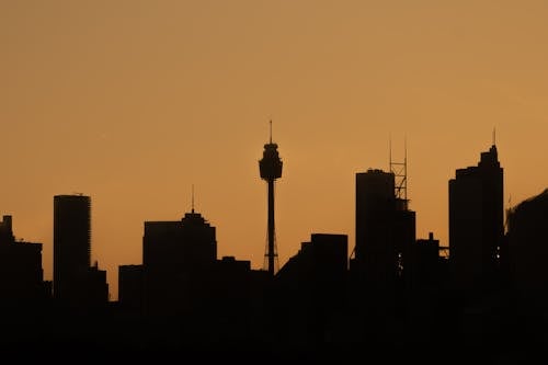 Silhouette of City Buildings and Broadcast Tower at Sunset