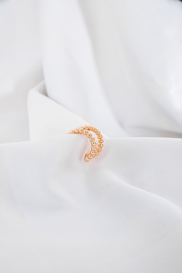 Golden Bracelet And White Fabric