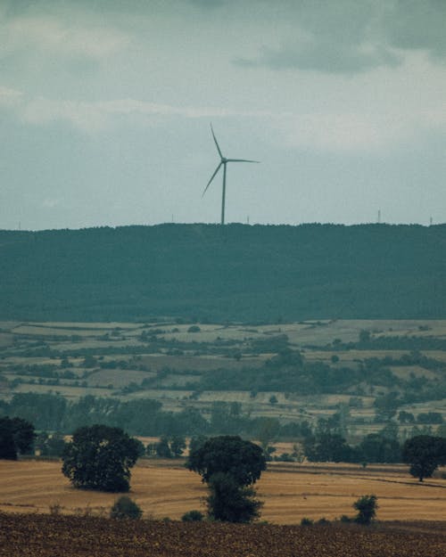 Free A Wind Turbine near a Rural Area Stock Photo