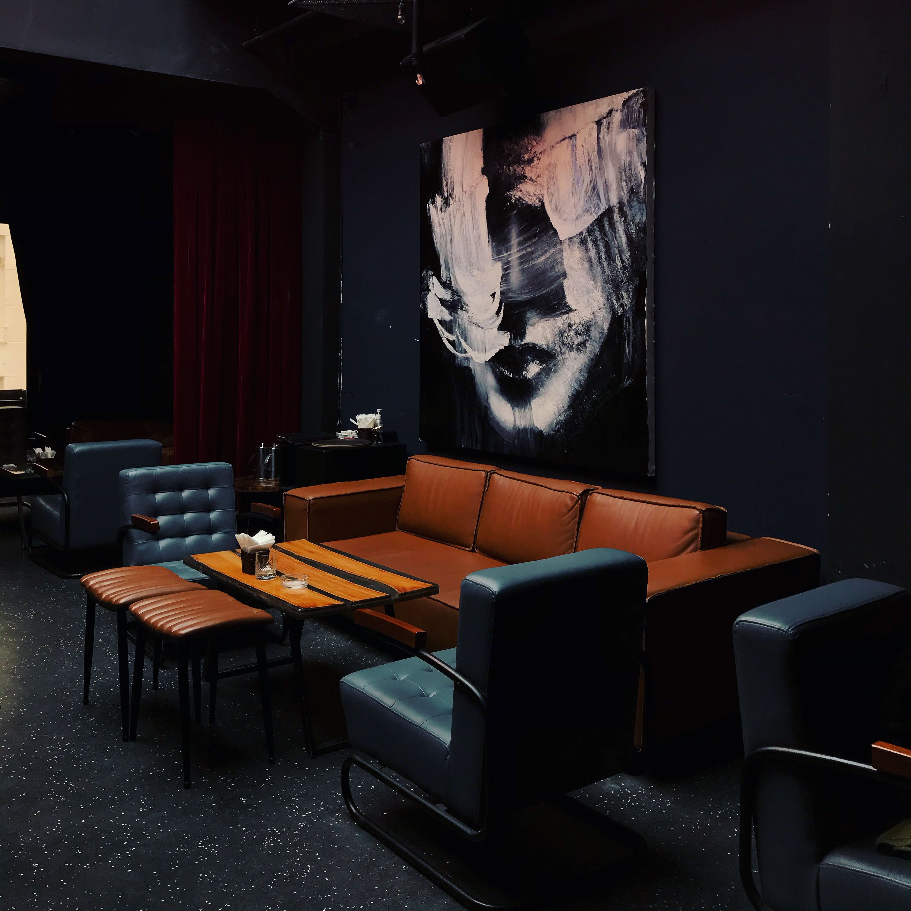 Stylish interior of a Vietnamese living room featuring modern seating and abstract painting.