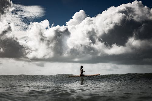 Free Photo of a Woman Sitting on Surfboard Stock Photo