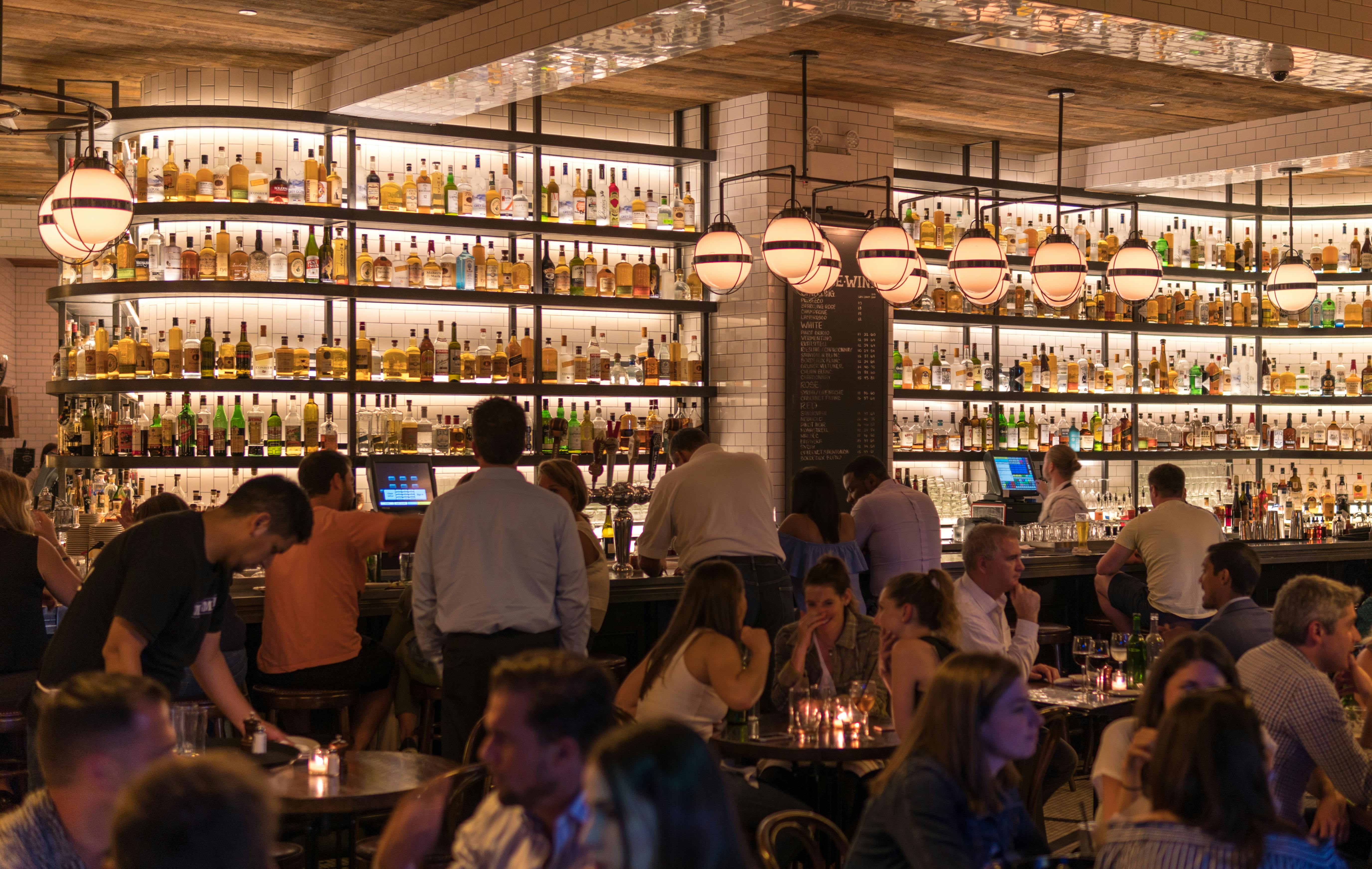 Group of people gathering inside the bar | Photo: Pexels