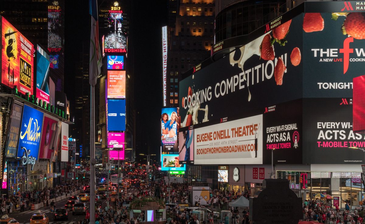 Times Square at night with neon billboards — limo service Midtown Manhattan