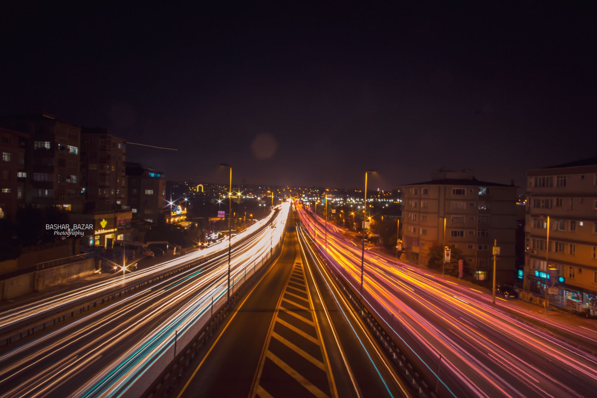 Vibrant long exposure of city traffic's light trails at night, showcasing urban energy and motion.