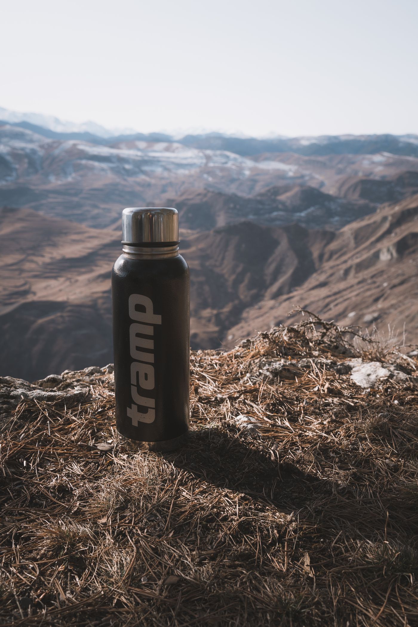 Insulated bottle on mountain terrain