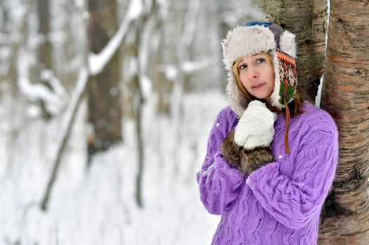 Caucasian woman in cozy winter clothing enjoying the snowy outdoors.
