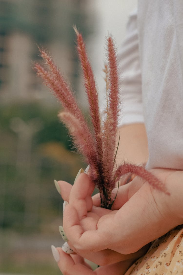 Woman Holding Plant Behind Back