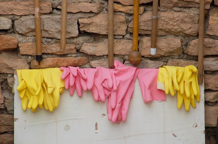 Pink And Yellow Rubber Gloves Hanging 