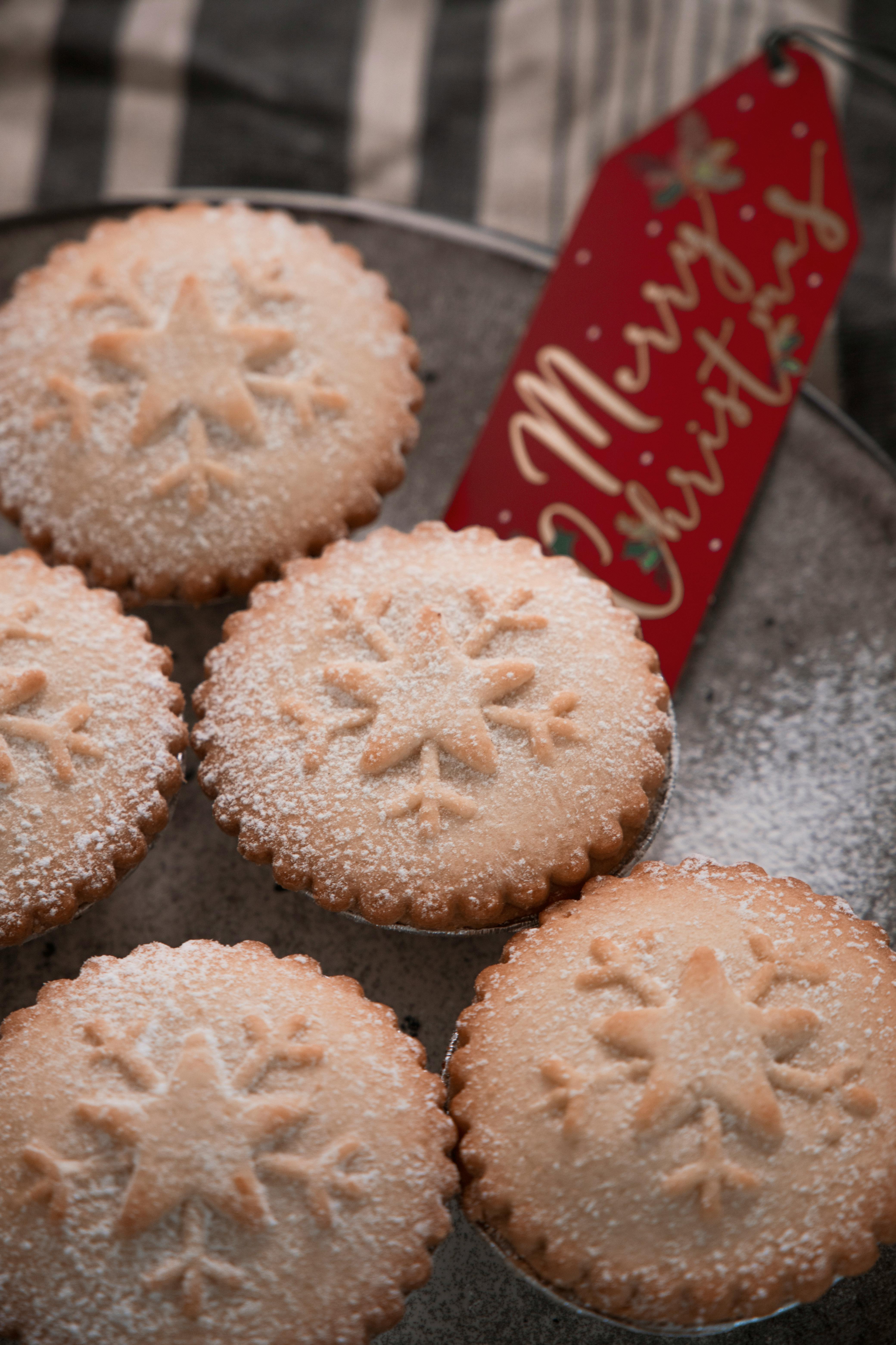 Close-up of snowflake cookies with a Merry Christmas tag, perfect for holiday baking.