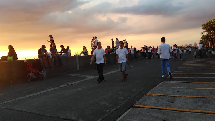 Group Of People Walking On Pavement