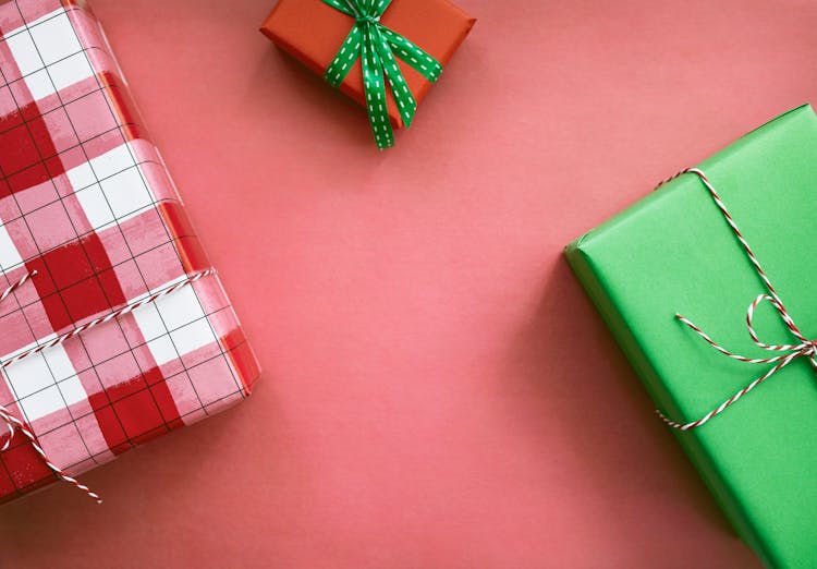 Top View Of Christmas Gifts With A Red Background