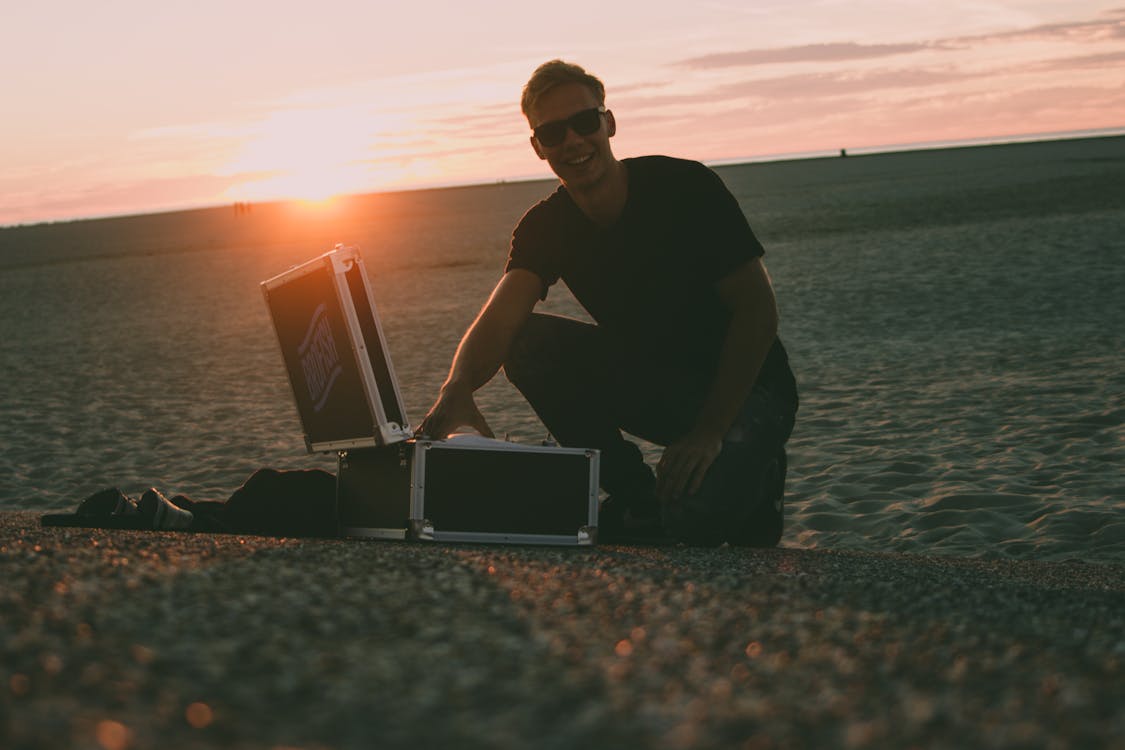 Free Man Near Black Flight Case Stock Photo