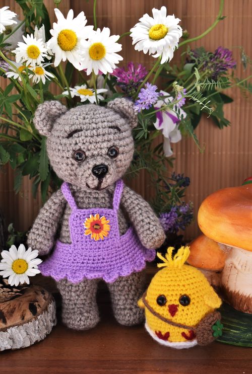 Free Cute handmade crochet bear and chick among flowers, perfect for decoration or gift idea. Stock Photo