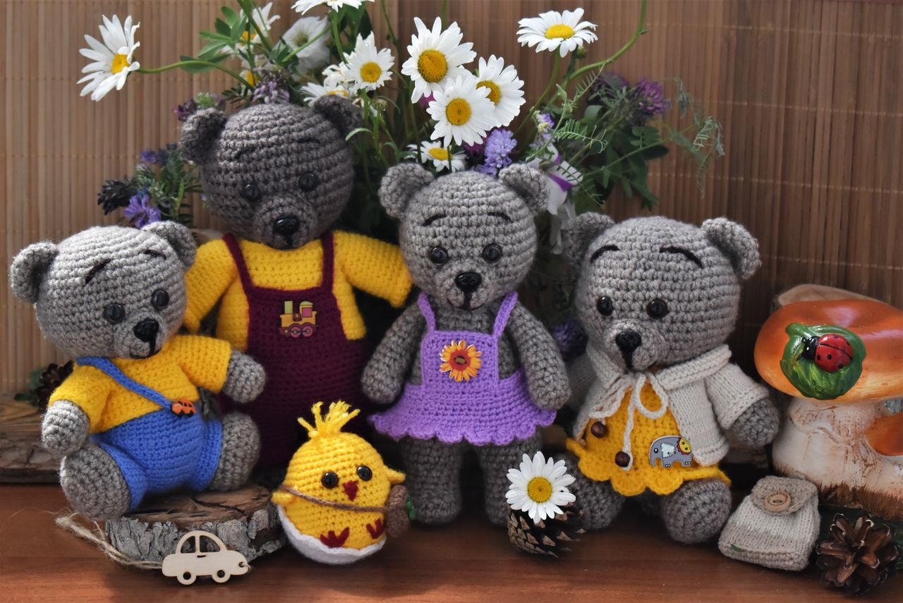 charming knitted teddy bears surrounded by colorful flowers perfect fo