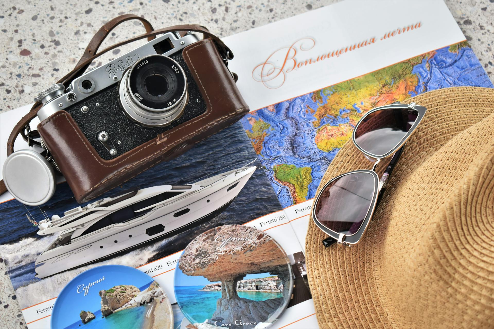 Explore travel with a vintage camera, map, and accessories perfect for a getaway.