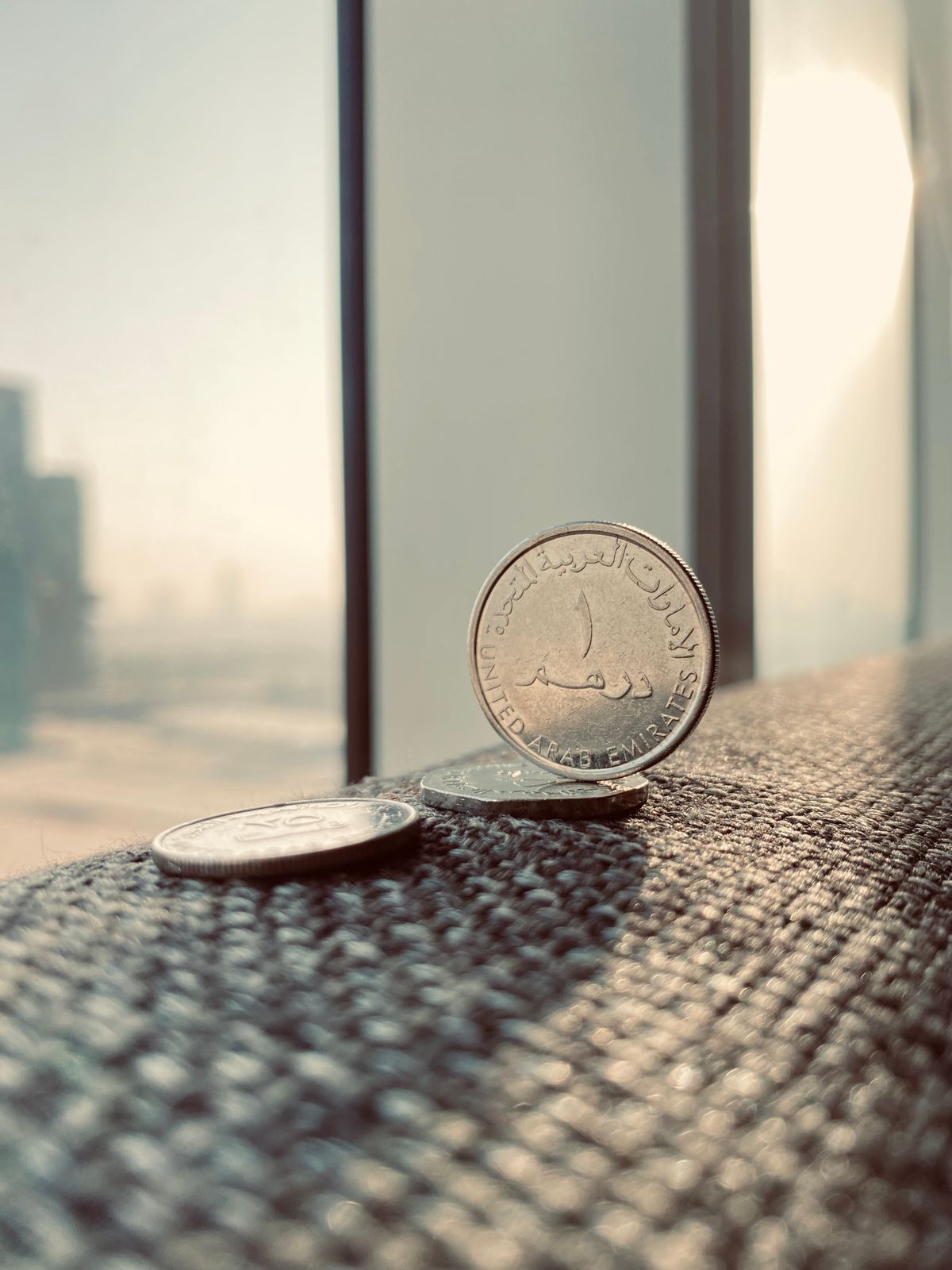 UAE dirham coins with Dubai skyline
