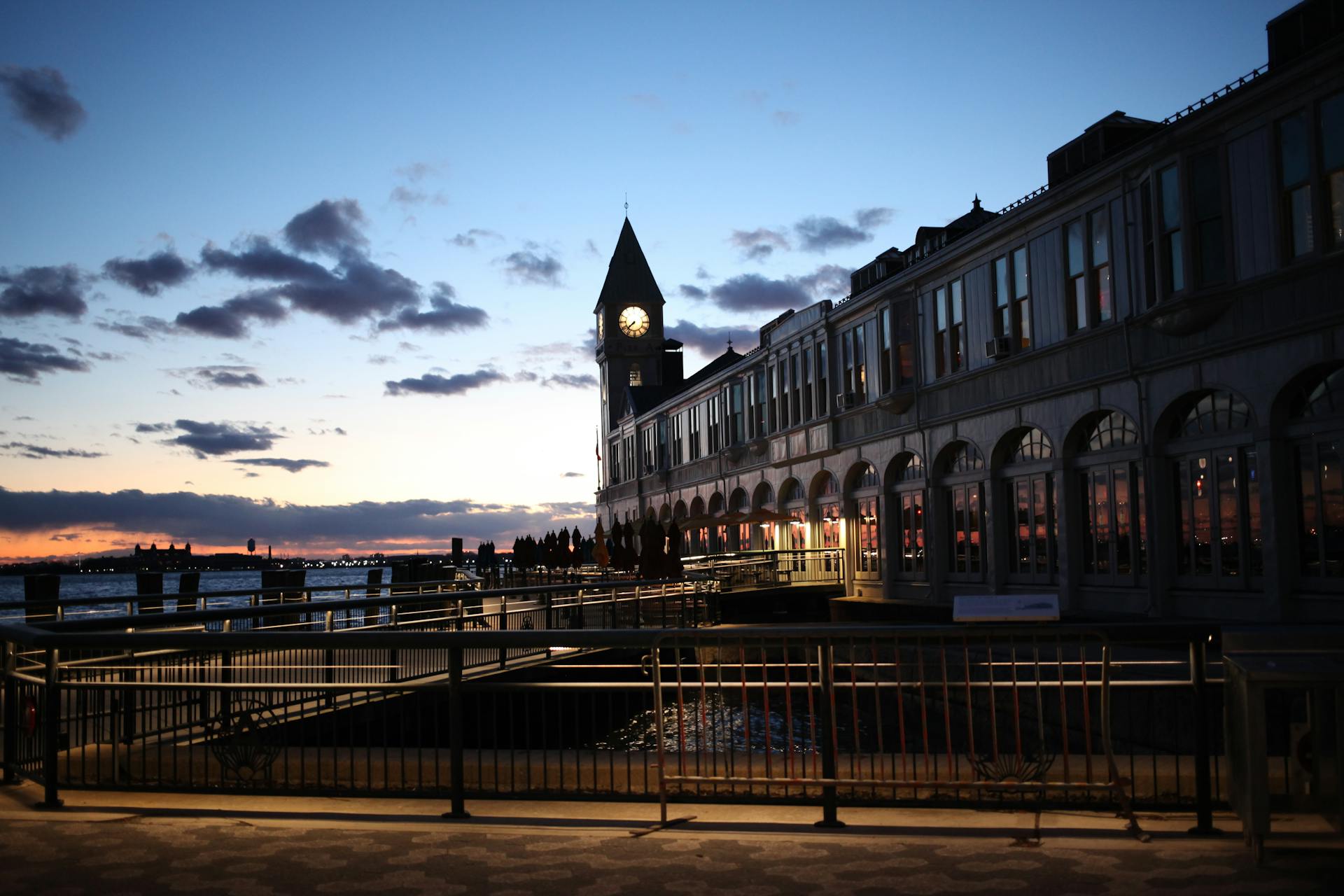Pier A Harbor House in New York City during sunset, capturing the iconic clock tower and waterfront ambiance.