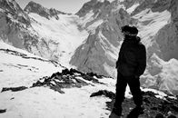Man in Black Jacket Standing on Snow Covered Ground