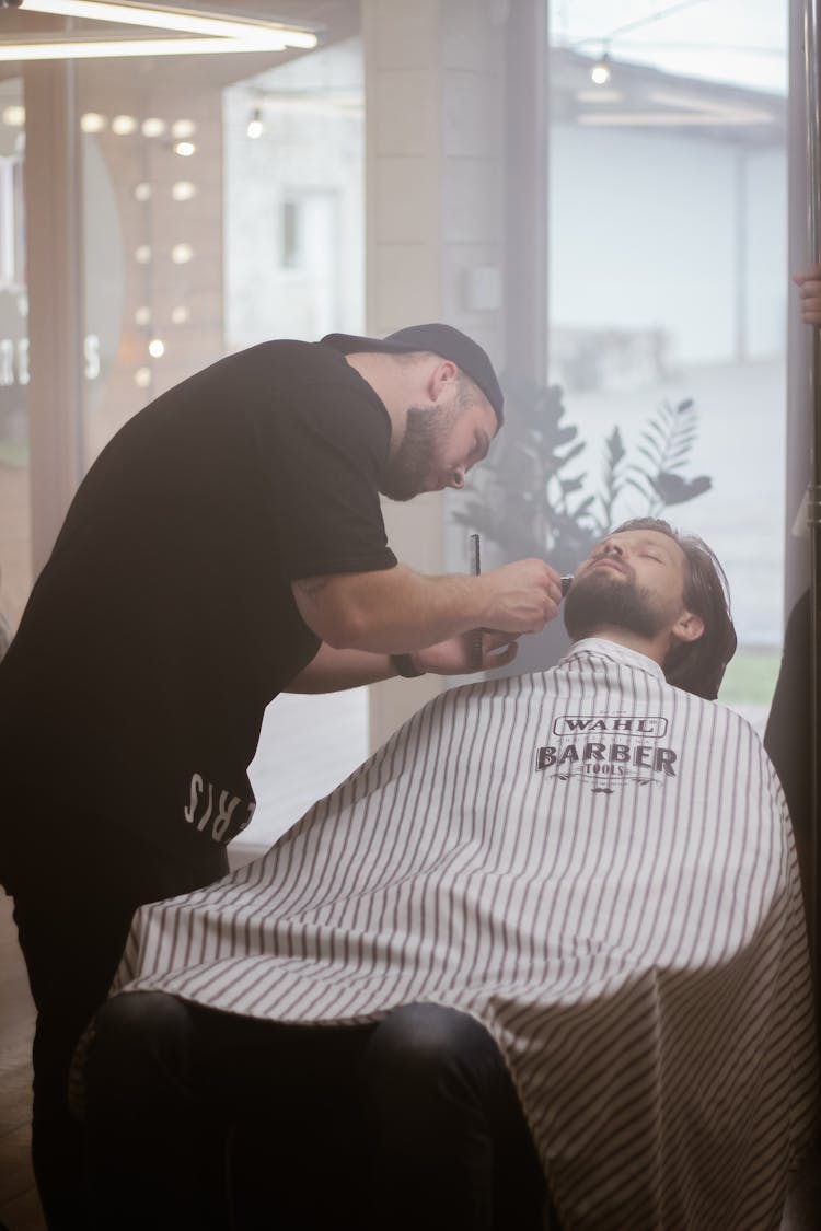 A Barber Cutting A Client's Hair