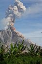 Erupting Volcano Under Blue Sunny Cloudy Sky