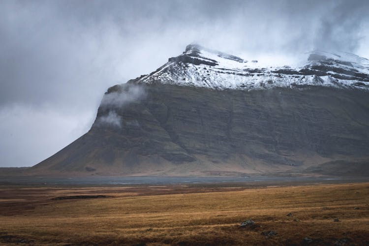 Landscape Scenery Of An Open Field Across The Mountain