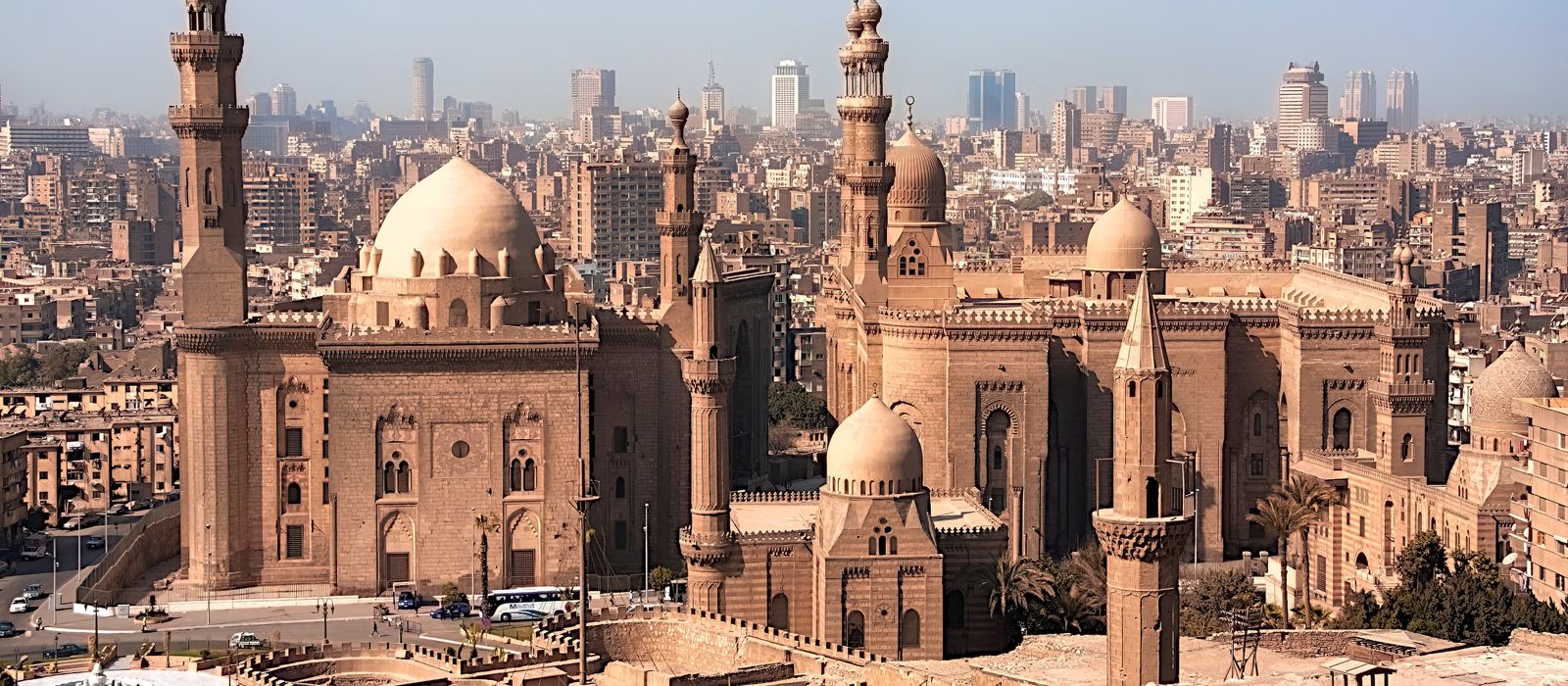 Aerial view of historic mosques with Cairo cityscape backdrop, showcasing Islamic architecture. — flights from Milan to Cairo