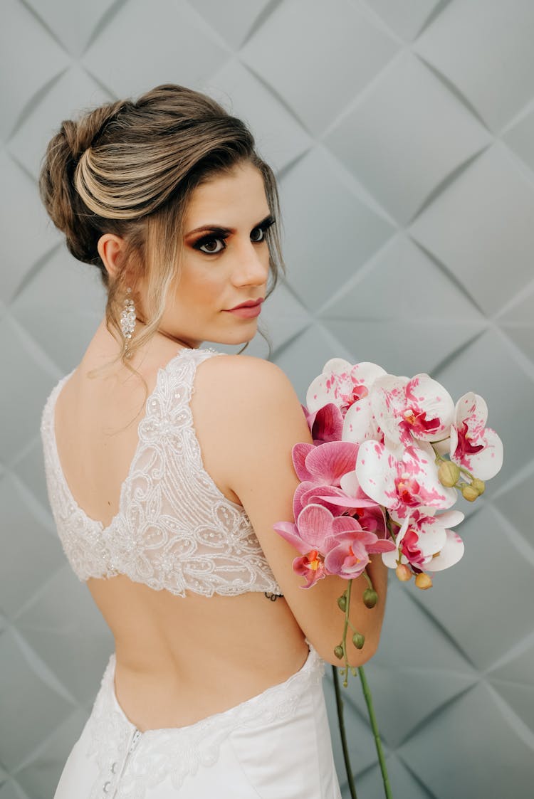 Woman In White Bralette Holding Orchid Bouquet